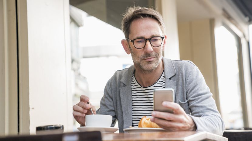 man viewing the full retirement age chart on a cell phone and trying to determine when to take social security