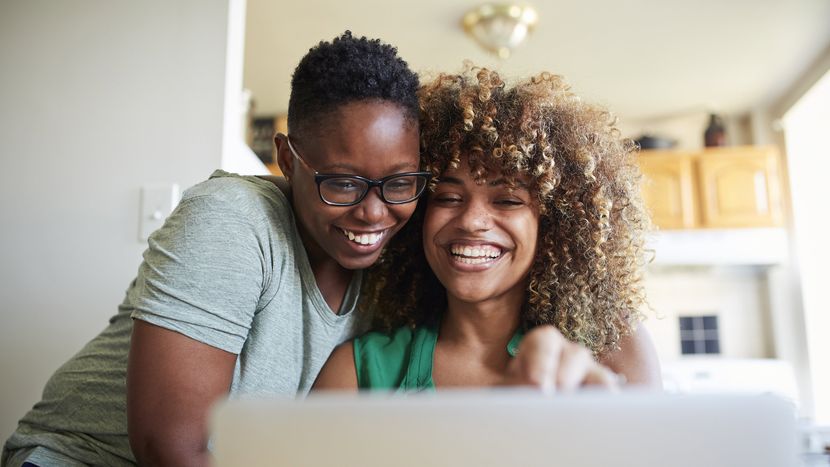 Couple looking at a computer and reading Northwestern Mutual's Complete Guide to Buying a Home