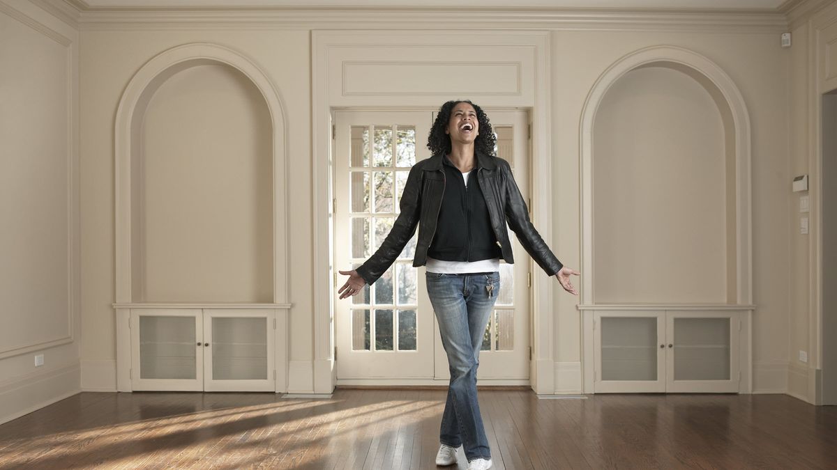 Woman in the living room of a home she wants to buy