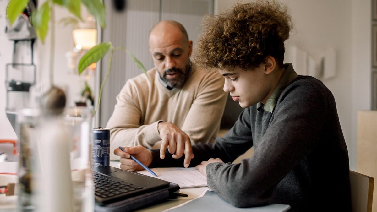 Father and son studying together and trying to figure out how to pay for college 