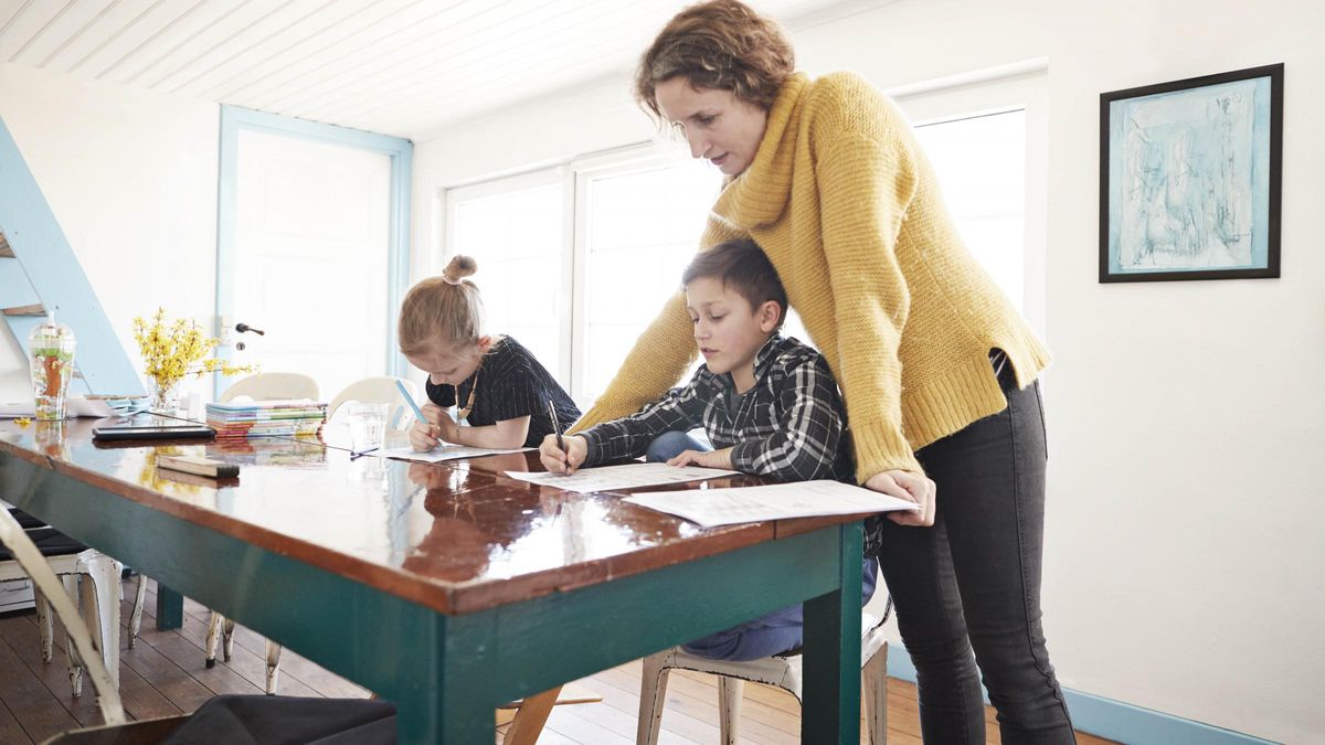 Mom studying with kids at table to prep them for college in the future