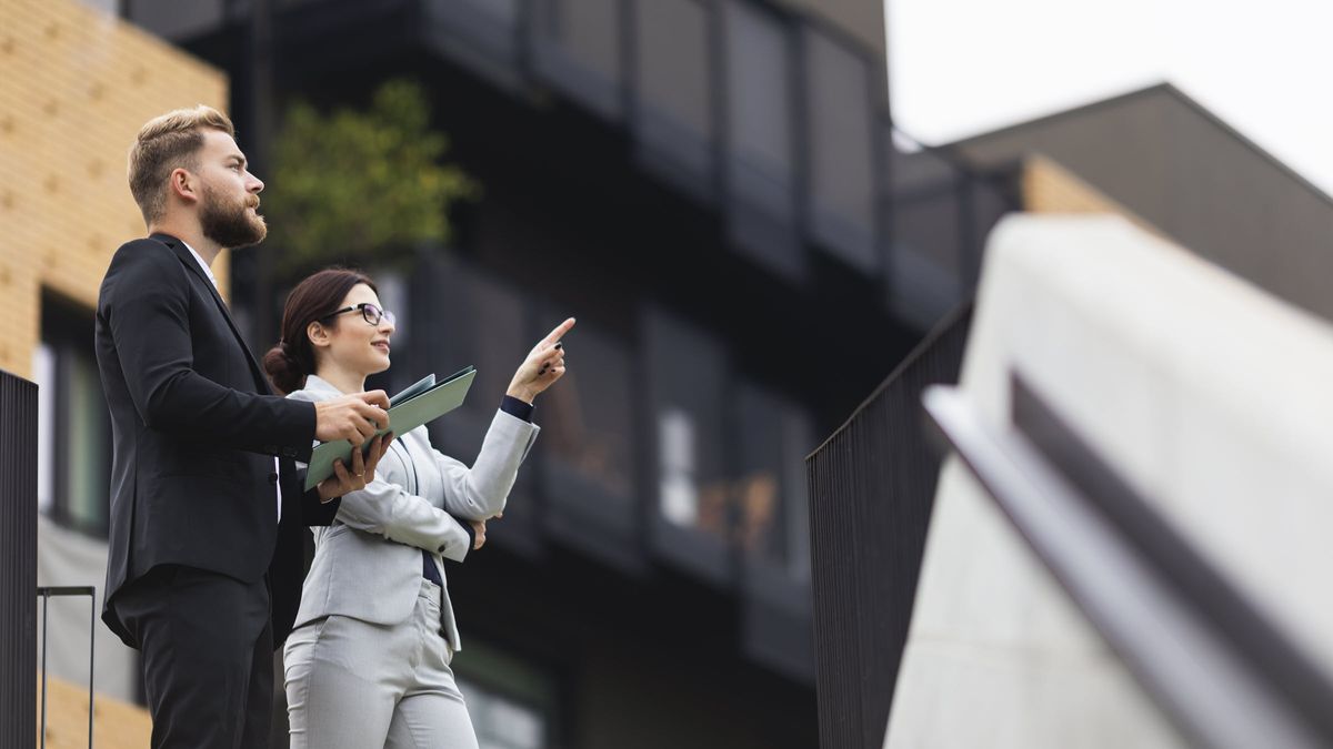 Woman and man looking at investment property