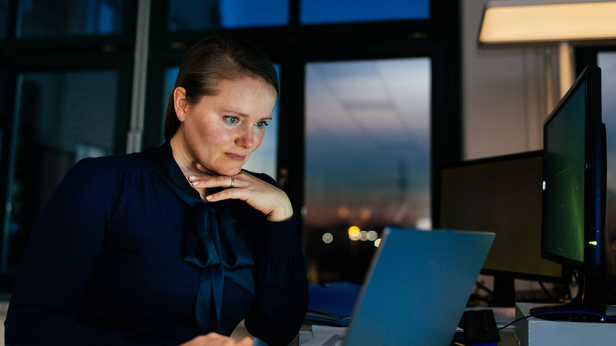 Woman looking at a computer reading about the bond market