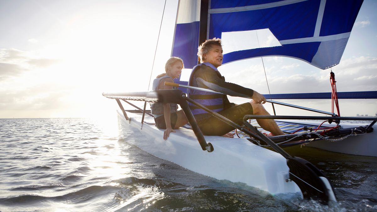 early retirement couple sailing a boat