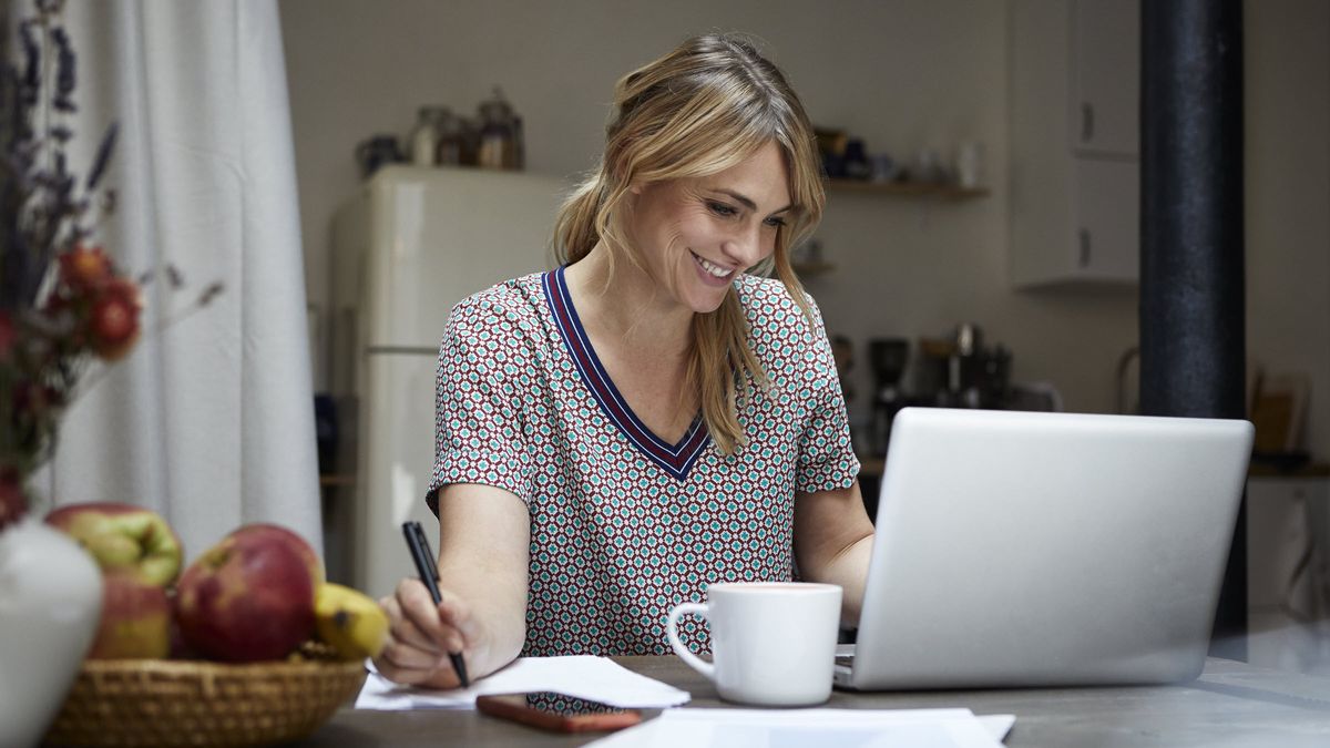 Woman looking at a laptop trying to determine what to do with a windfall