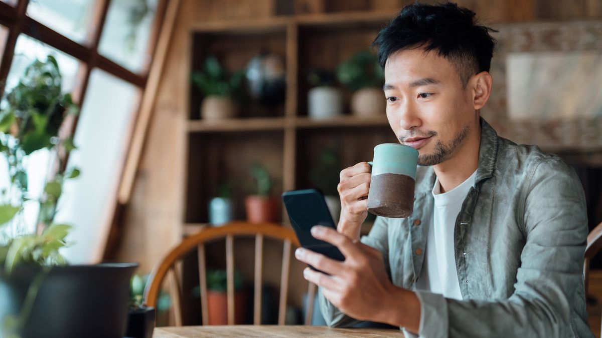 Young man reading about investing in stocks.