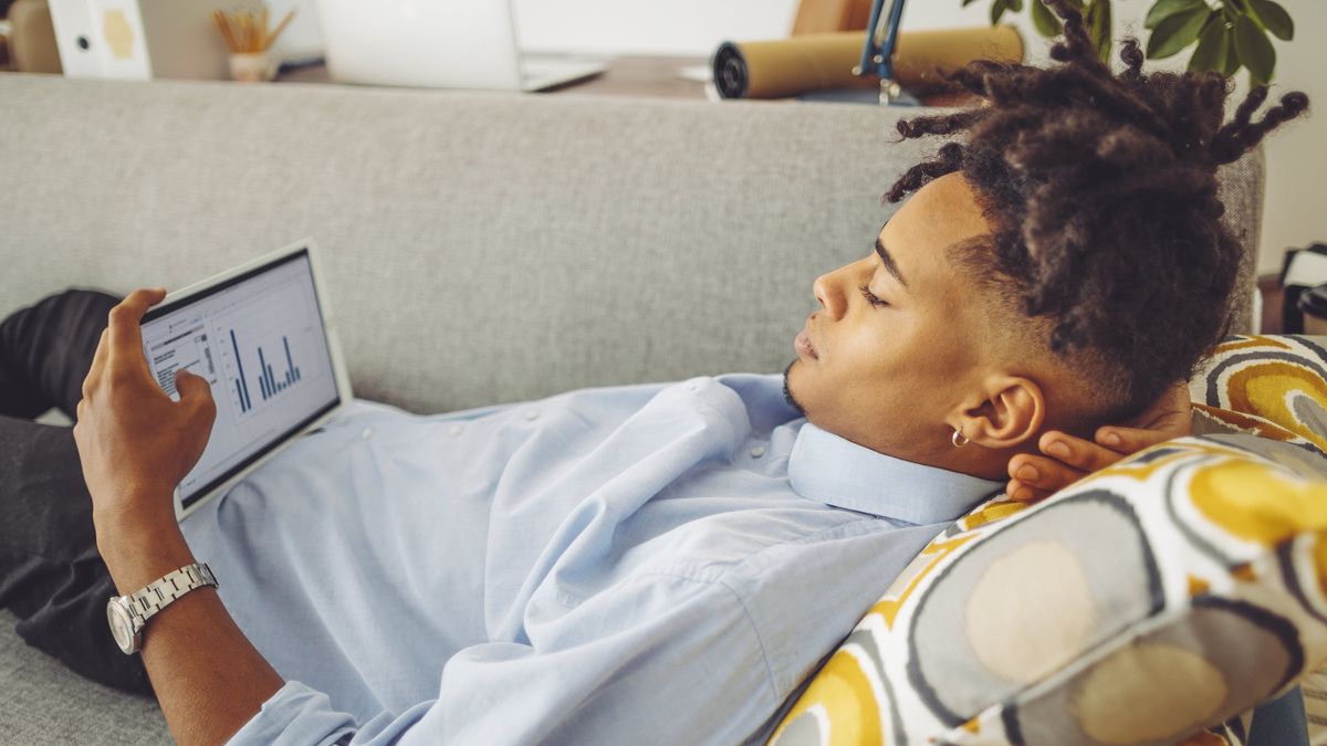 A young investor looks at a mobile device.