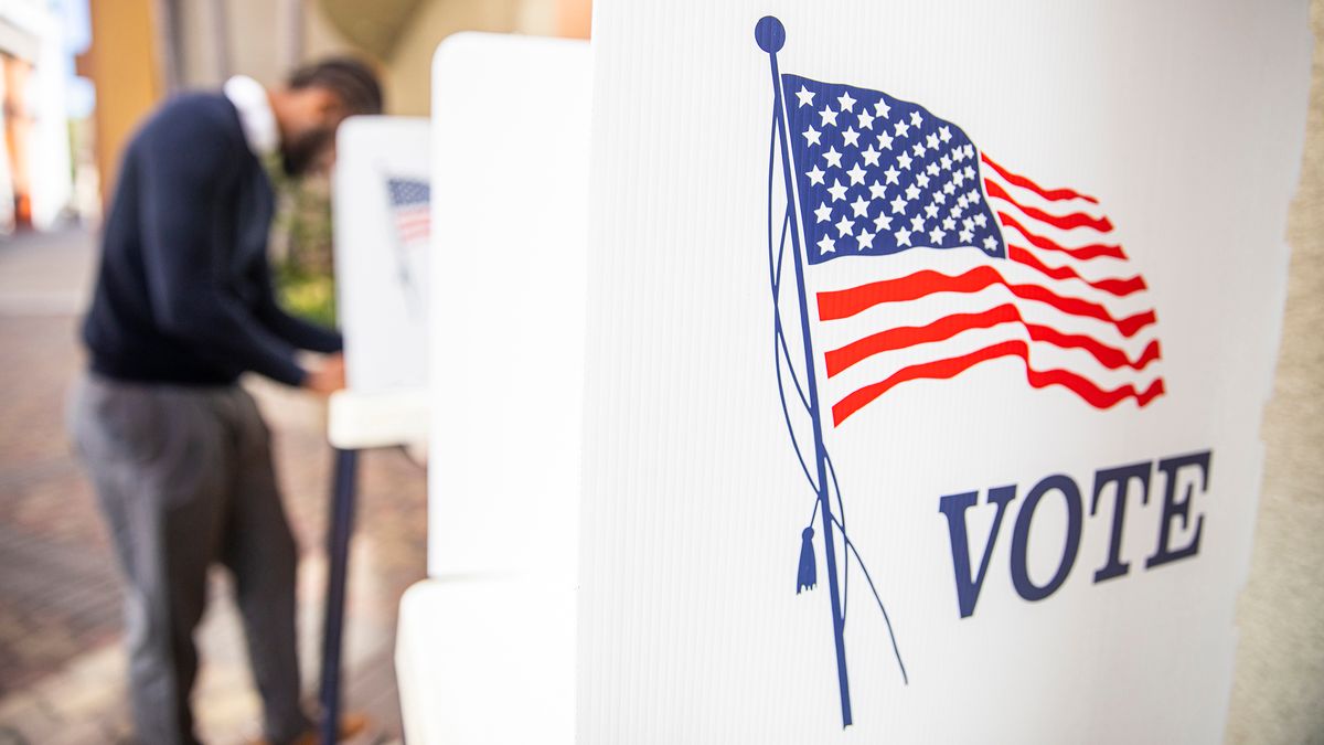 Man filling out election ballot