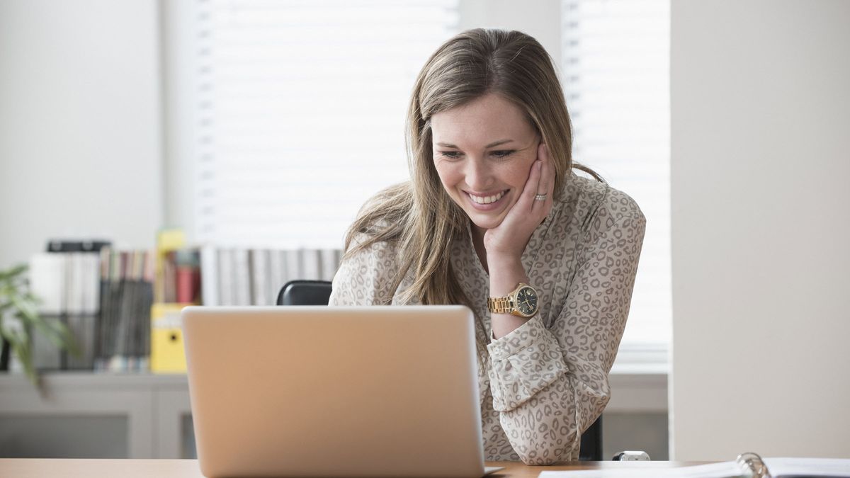 Woman looking at computer researching certificate of deposit