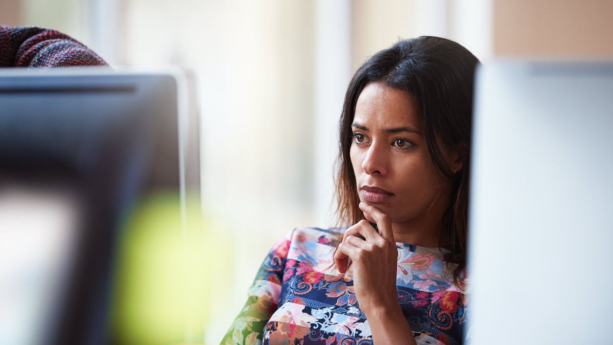 Woman looking at a computer screen, researching brokerage accounts.