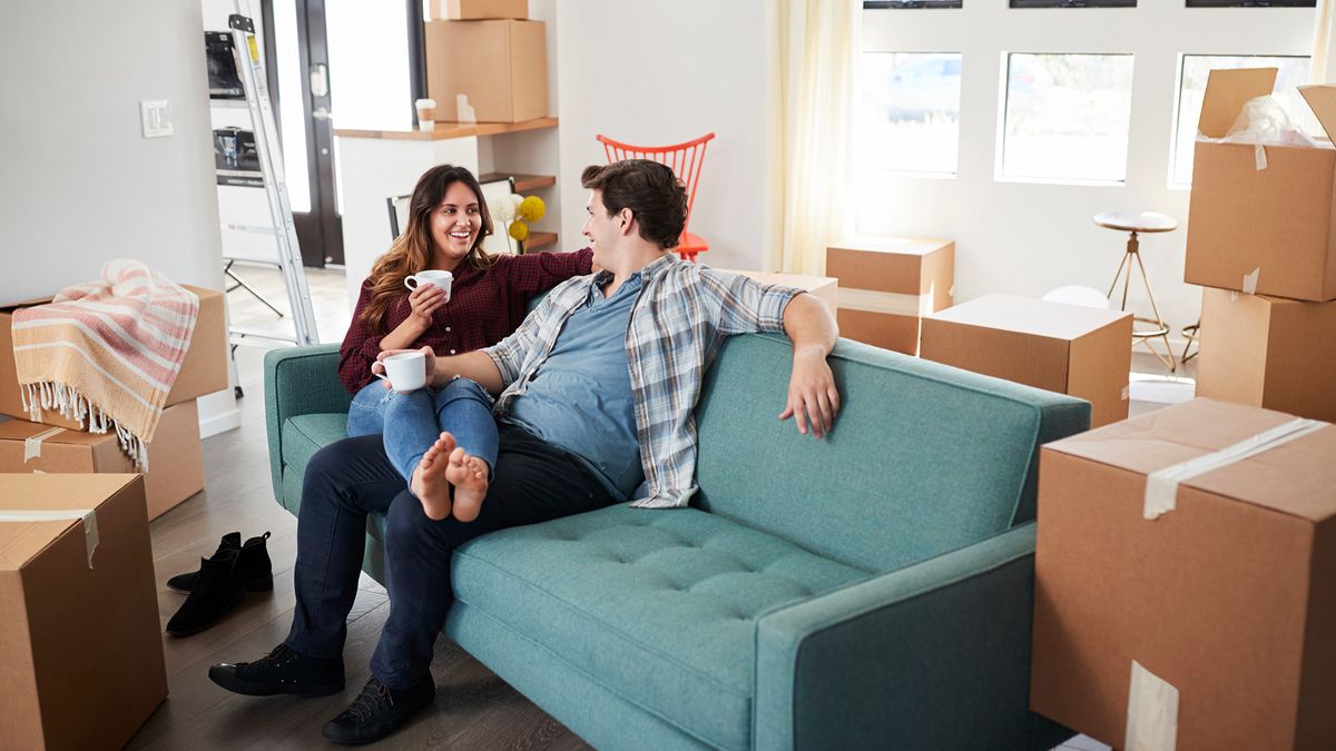 couple on couch moving into new home