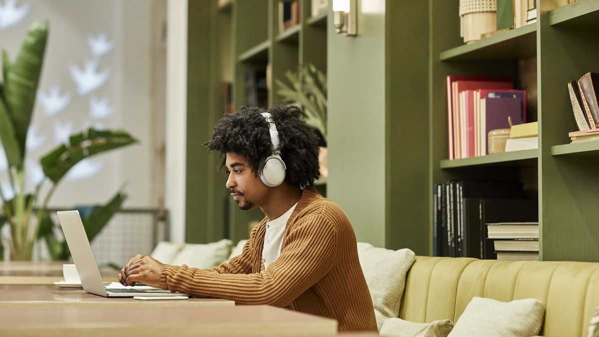 Man wearing headphones researching Gen Z guide to retirement planning.