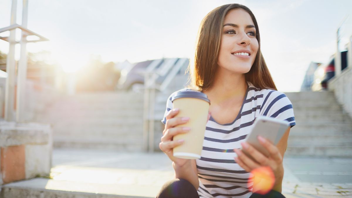 Woman drinking coffee looking to keep her financial new year's resolution