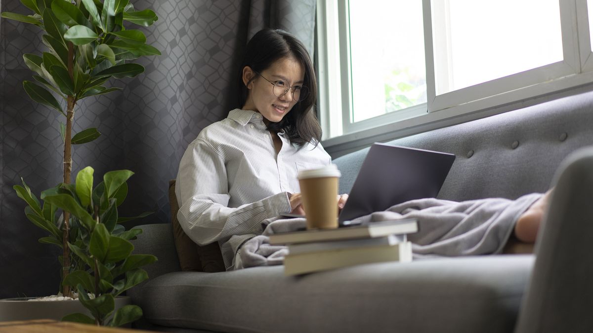 Woman reading about what a pause in interest rate hikes may mean for her.