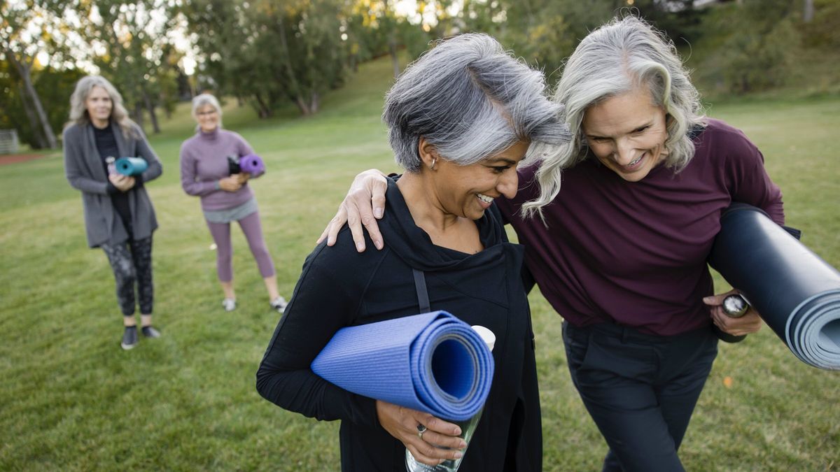 retired women walking with yoga mats