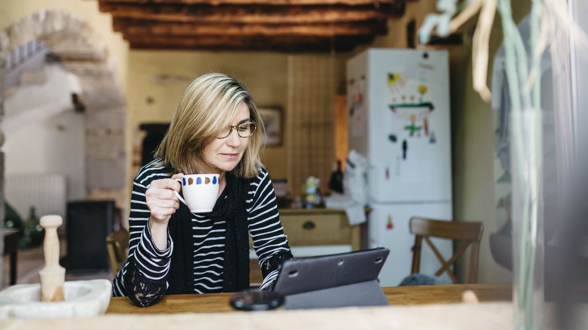 Woman reading news about recent credit downgrades.