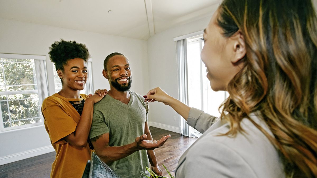 Couple moving into new home after taking out an adjustable-rate mortgage.