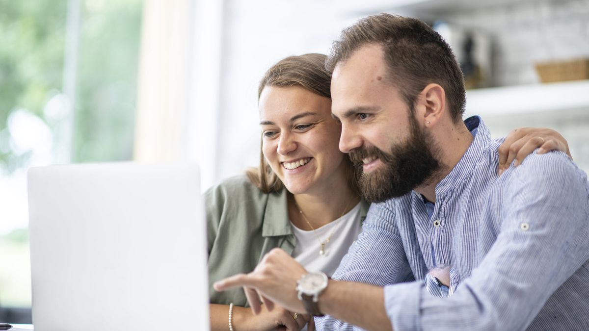 Couple looking at a computer screen reading about the secret to getting more out of retirement savings