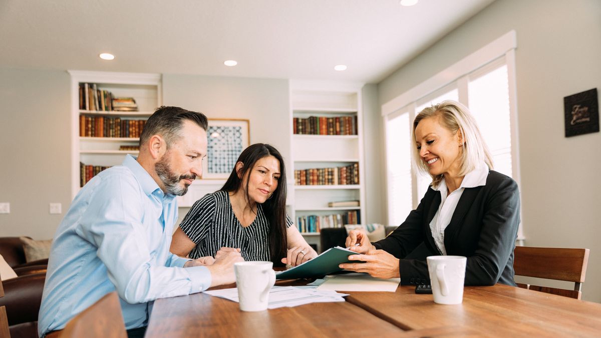 Couple meeting with a financial advisor and discussing sequence of returns risk.