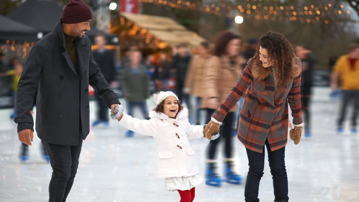 Couple thinking about Northwestern Mutual’s Weekly Market Commentary as they help their daughter keep her balance.