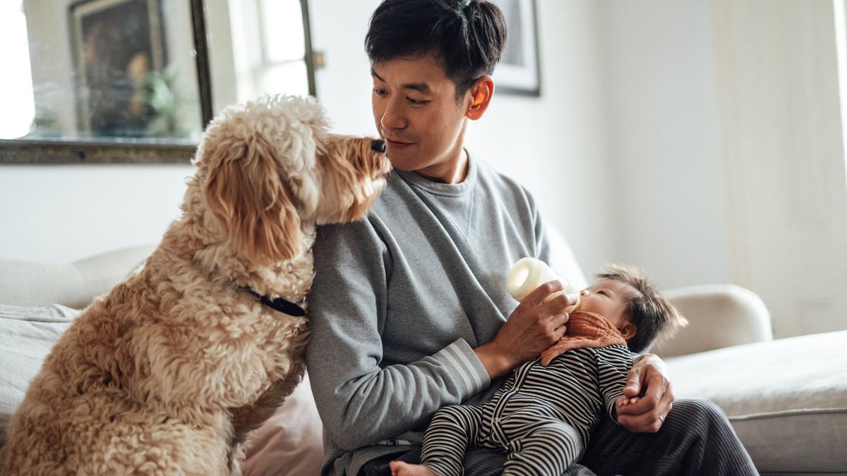 Young father with dog and daughter relaxing in the knowledge of a solid financial plan with Northwestern Mutual.