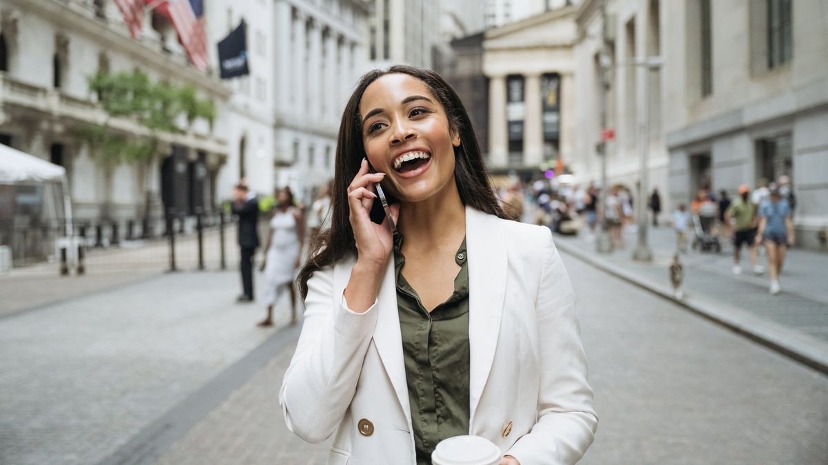 A smiling, confident Wall Street businesswoman actively investing in her future and working toward financial security with expert guidance from a Northwestern Mutual Wealth Management Company certified financial planner. This image conveys financial success, modern wealth management, and professional financial planning.