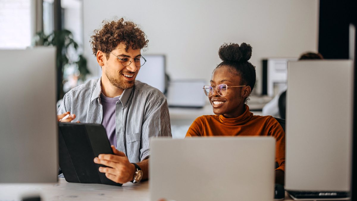 Male and female colleague in a modern office. This image conveys financial success, modern wealth management, and professional financial planning.