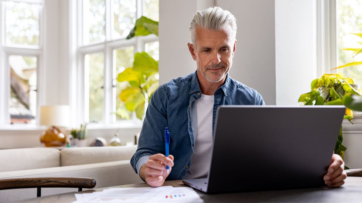 Man reading the Northwestern Mutual Wealth Management Company’s Weekly Market Commentary in a modern office. This image conveys financial success, modern wealth management and professional financial planning.