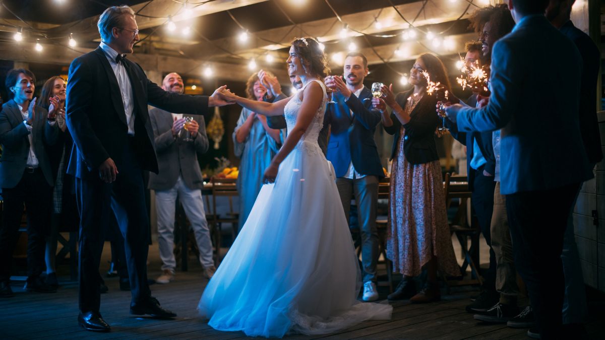 A couple dances in a wedding tent
