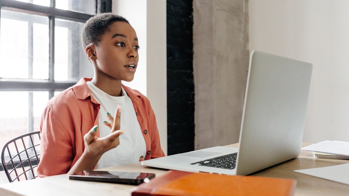 A woman in a modern office reading Northwestern Mutual Wealth Management Company Weekly Market Commentary and analyzing the economic fallout of the Iran war and the blockade of the Strait of Hormuz, which has triggered a spike in global inflation and stalled Federal Reserve rate cuts.