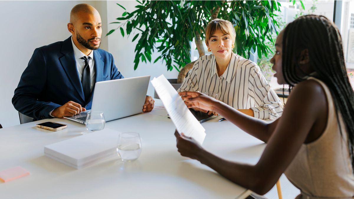 Formal business team having a meeting, discussing documents, and reviewing wealth management tools and investment strategies