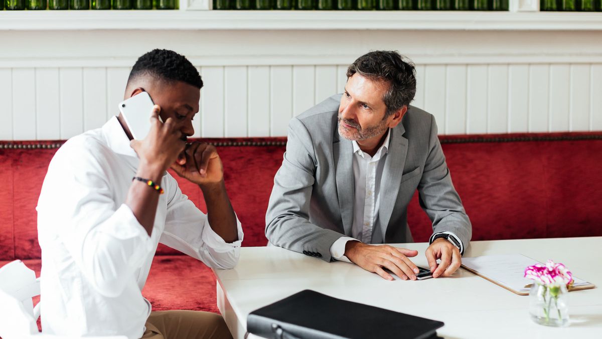Businessmen discuss markets and economy between meetings in a modern coffee shop 