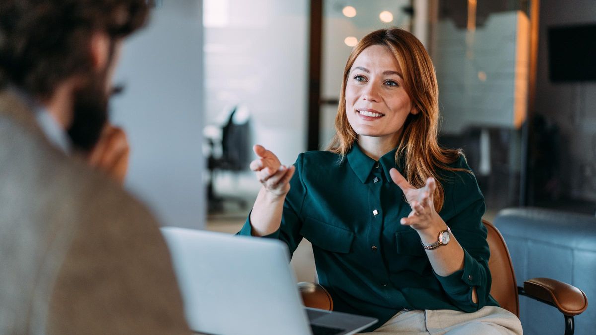Shot of two colleagues having a discussion in the office.