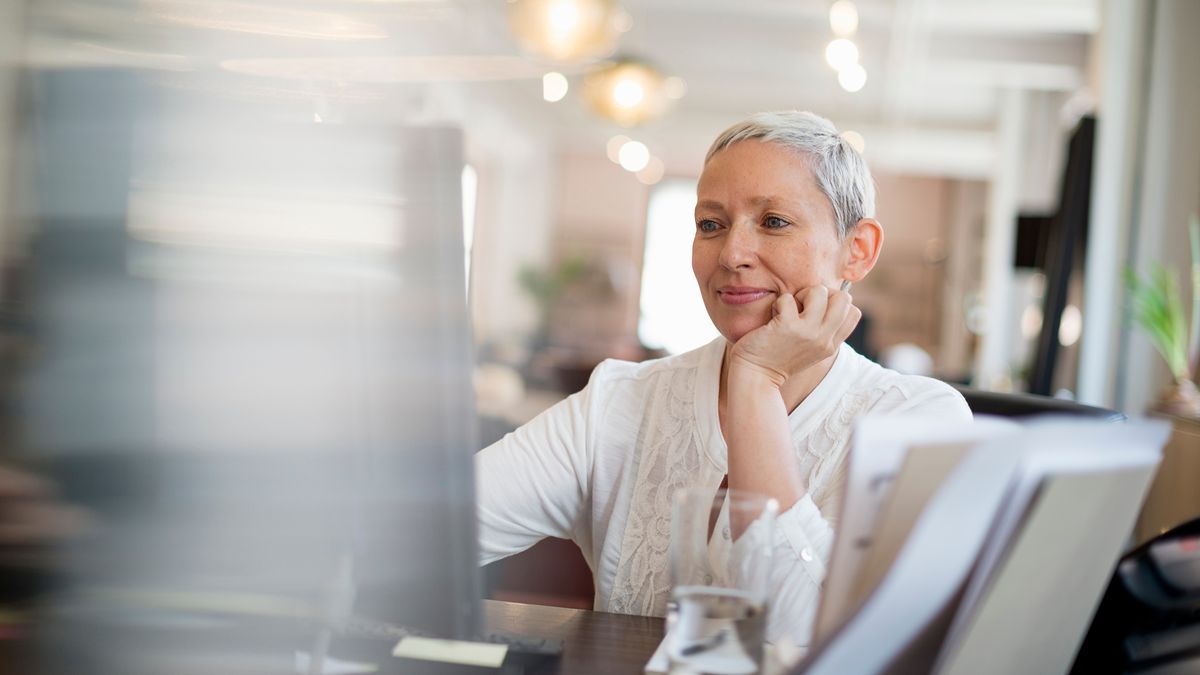 Woman looking at computer learning about types of annuities