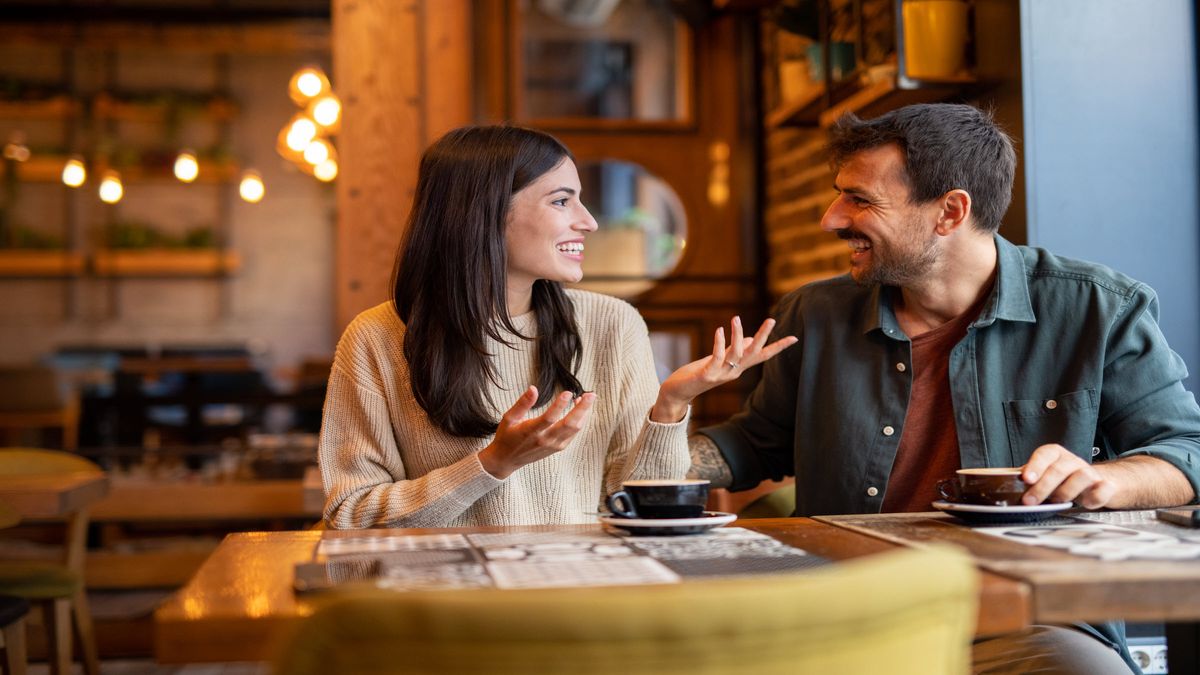 Happy couple having a coffee date in cafe