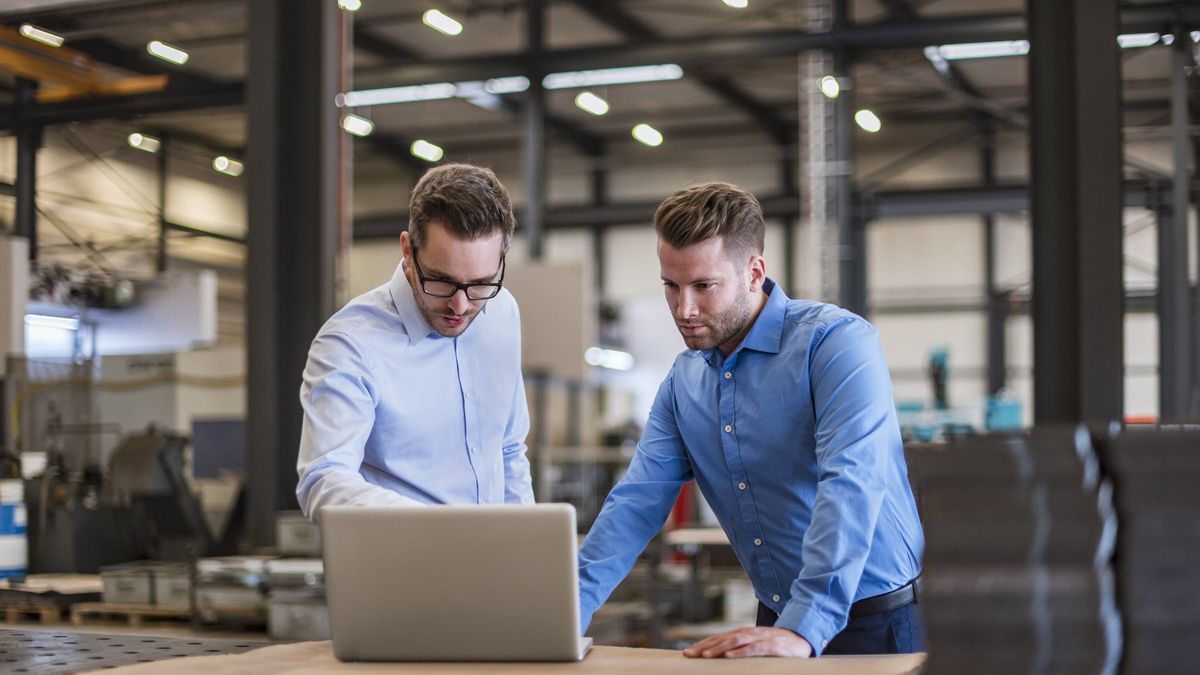 Men taking inventory of warehouse before tariffs hit.