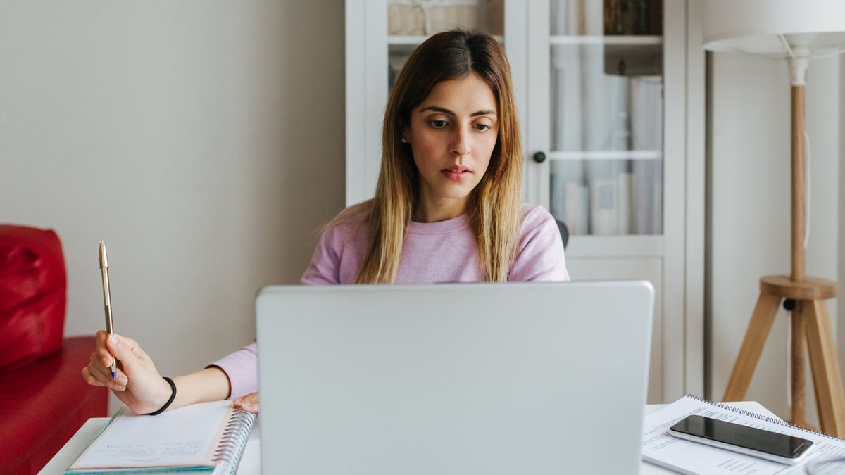 Young woman with laptop analyzes financial markets and her well-diversified stock portfolio, crafted with an expert financial advisor from Northwestern Mutual Wealth Management Company  