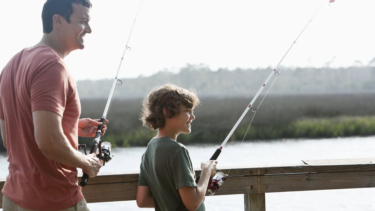 Dad fishing with son and wondering how tariffs will affect the economy.
