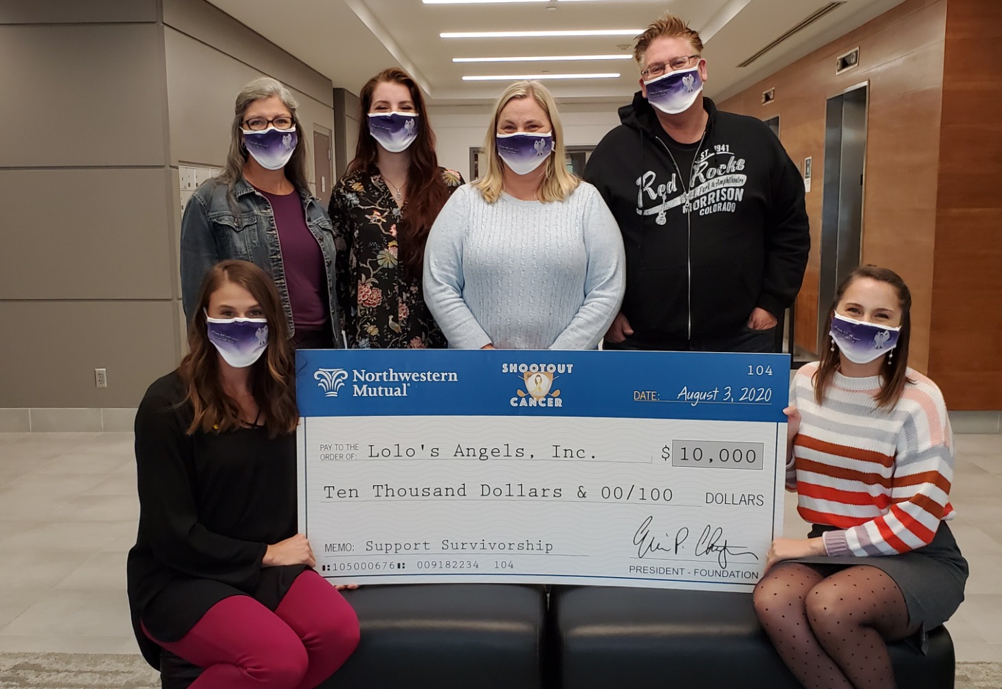 Directors of the Northwestern Mutual Childhood Cancer Board of Directors, Taylor Barnes (front left) and Taylor Belling (front right), and Lolo's Angels Inc. with Northwestern Mutual's $10,000 donation.