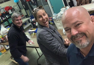 Jeff, Madison and Todd wrapping diapers for the NC Diaper Bank in their warehouse.