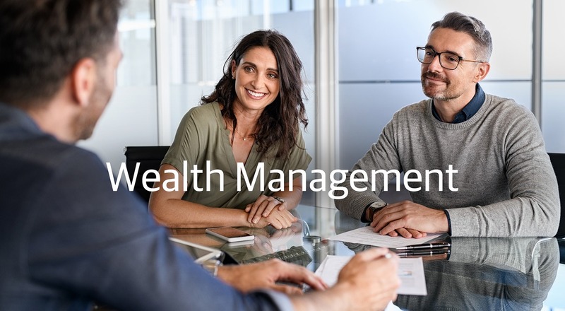 Wealth Management. Affluent couple talking with financial advisor.