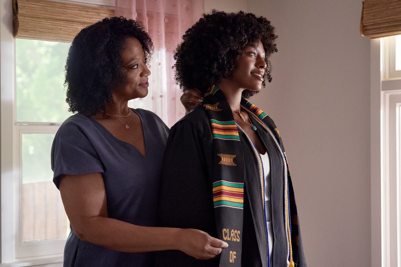 Mother and Daughter trying on graduation gown