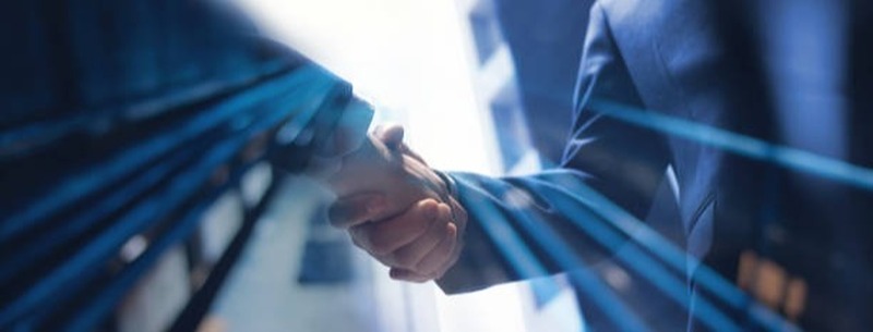 Image depicting the value of partnership. Two people shaking hands.
