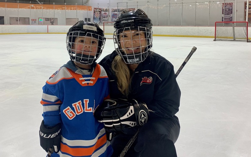 Kristen and her son playing hockey.