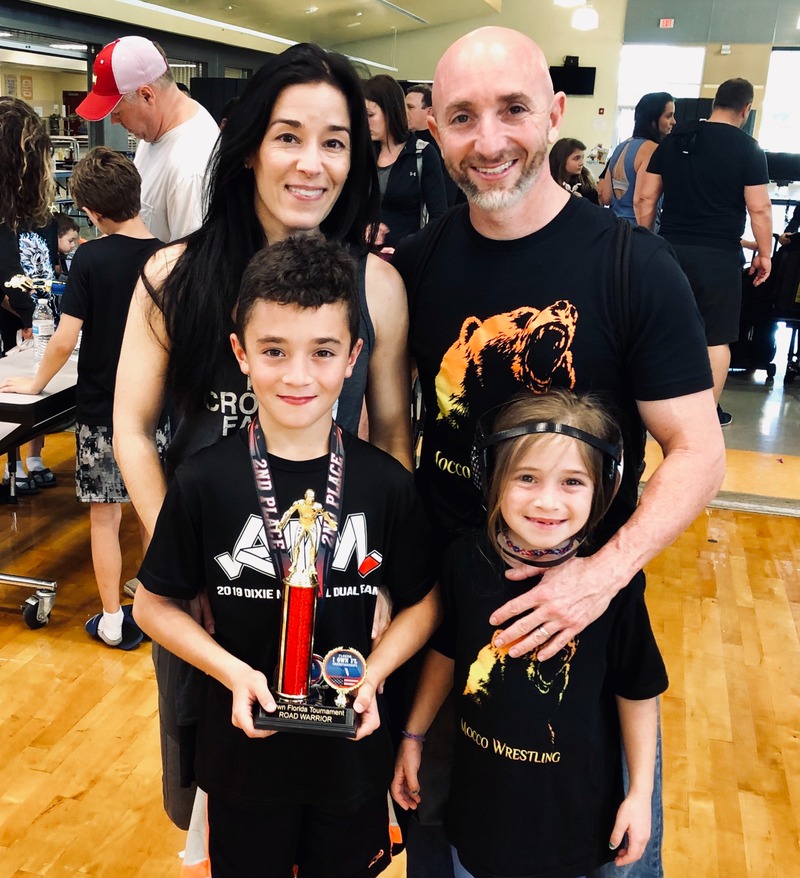 Female Advisor with her family at wrestling tournament
