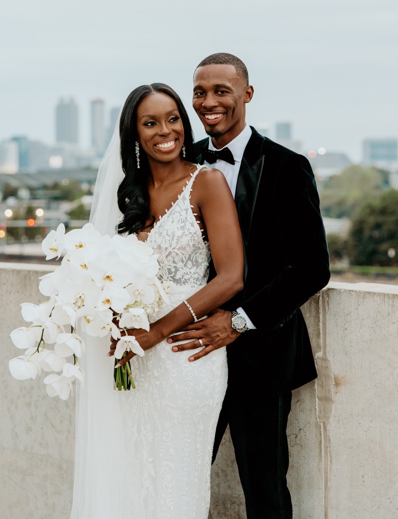 Derrick Murray, CFP with his wife after their wedding smiling happily.