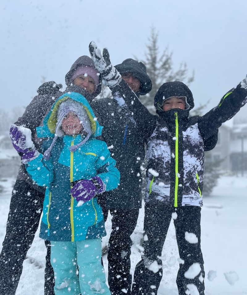 Female advisor with family in the snow