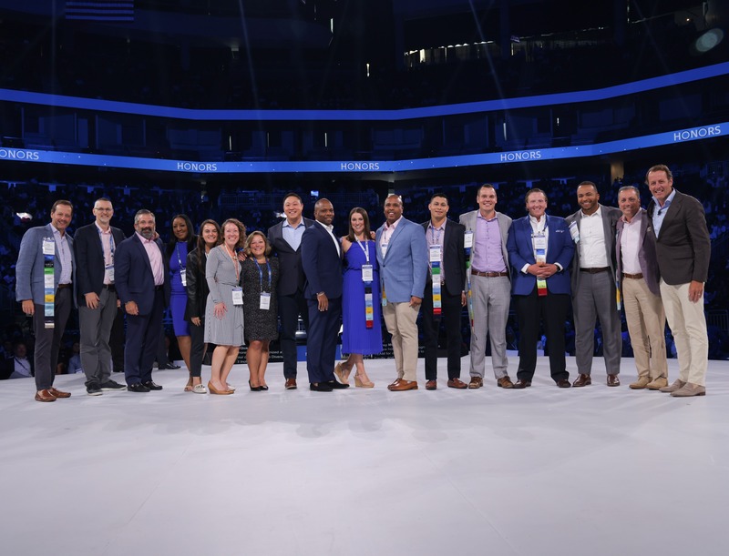 group of diverse people on stage accepting an award