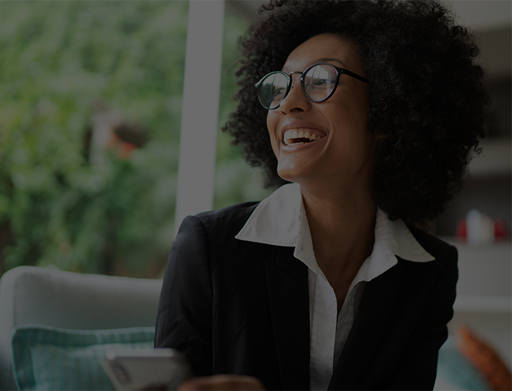 A financial advisor smiling while looking out the window.